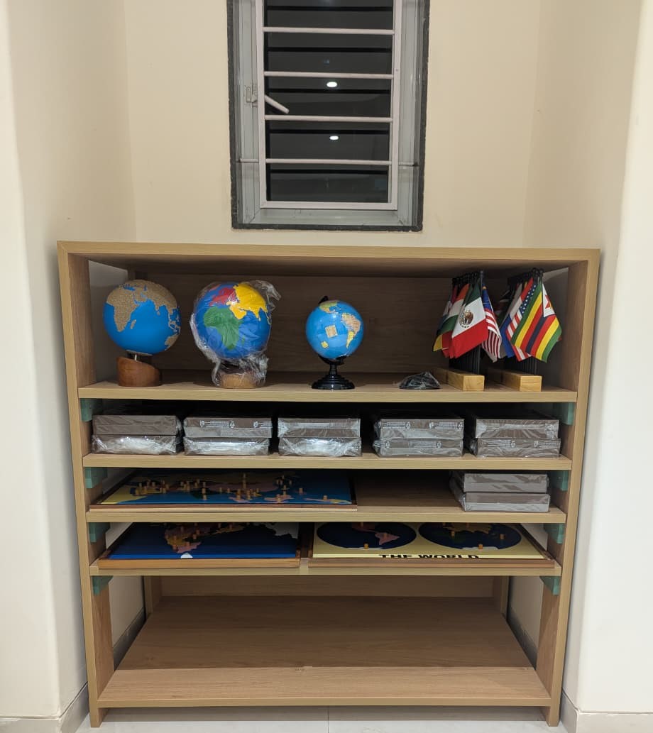 Child exploring geography materials at TinyTrails Montessori